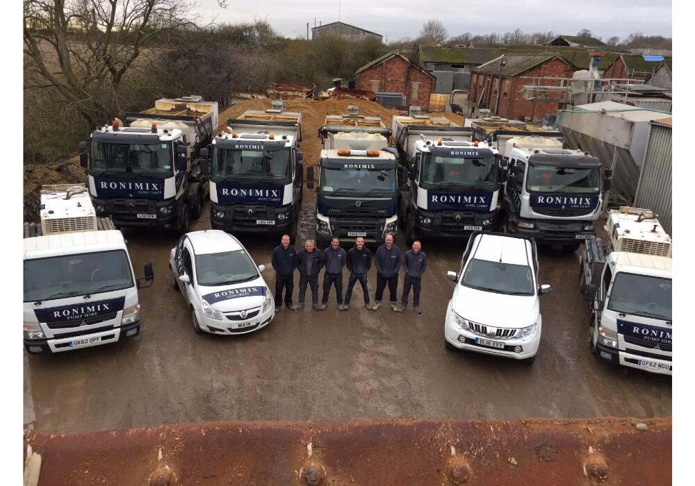 First image of Ronimix old team with Cat loader & concrete vehicle fleet showing bucket edge