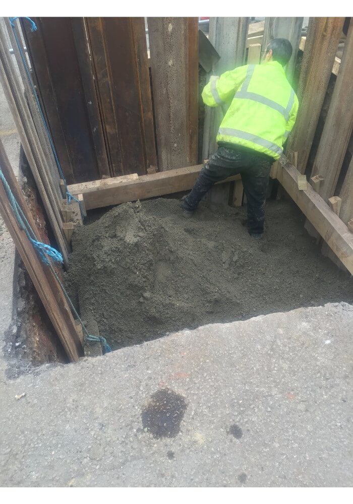 Ronimix concrete delivered into a deep hole with operative levelling it out