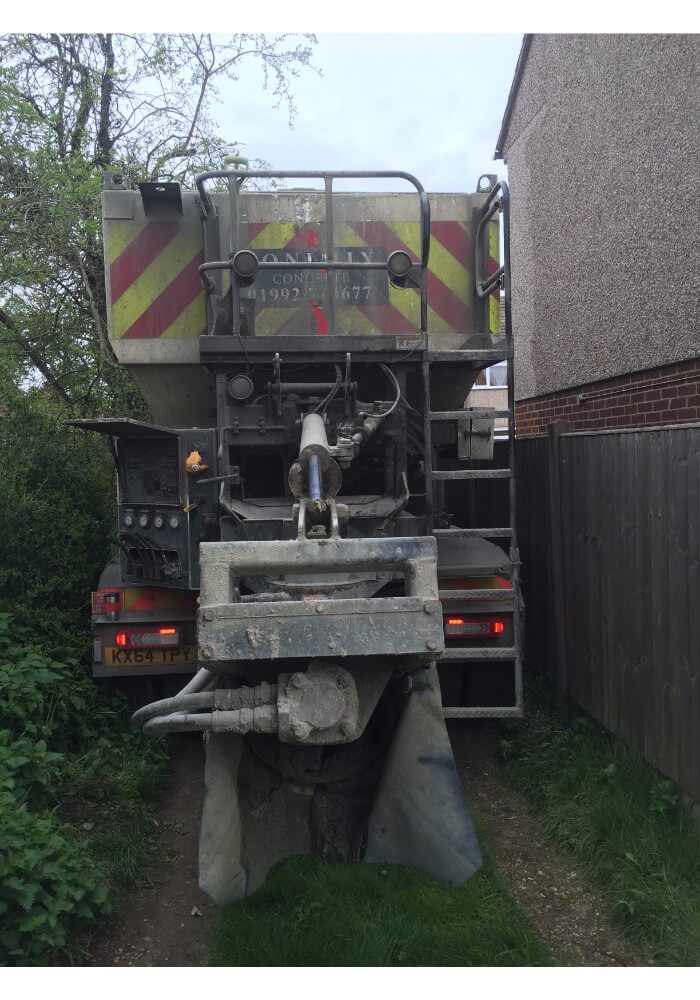 Volumetric concrete lorry squeezing down a tight alley