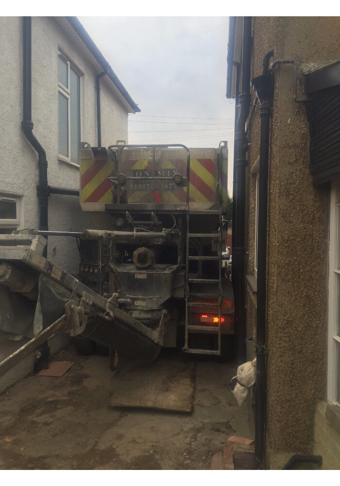Volumetric concrete lorry squeezing between houses- stopped by svp